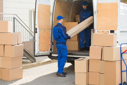 Removal van and moving boxes in Barking residential street