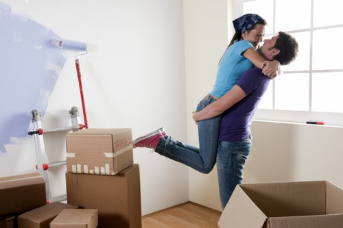 Boxes and furniture ready for transport by man with van