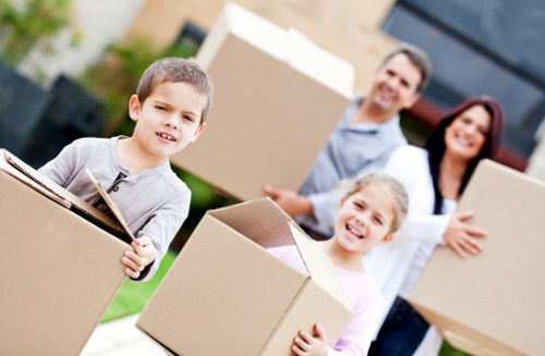 Moving helper carrying household items for Barking customer