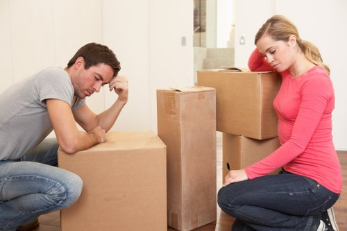 Family preparing for a local house move with boxes and furniture in Barking