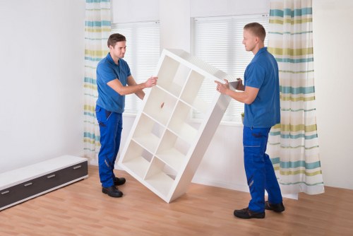 Local movers handling furniture and boxes during a Barking move